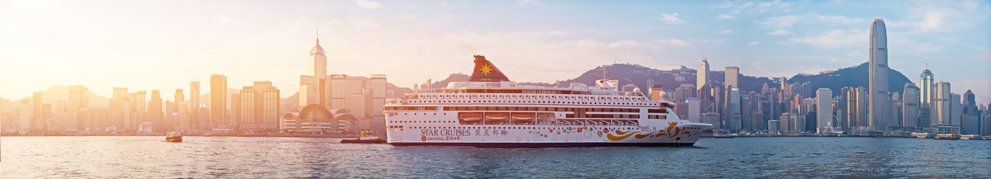 HONG KONG - JAN 13: Victoria Harbor on Jan 13, 2016 in Hong Kong. Big Cruise Ship departed from Ocean Terminal and drove across Victoria Harbor at sunrise.