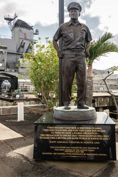 Oahu, Hawaii, USA. - January 10, 2020: Pearl Harbor. Bronze statue of Fleet Admiral Chester W. Nimitz near where USS Missouri, in back, is docked.