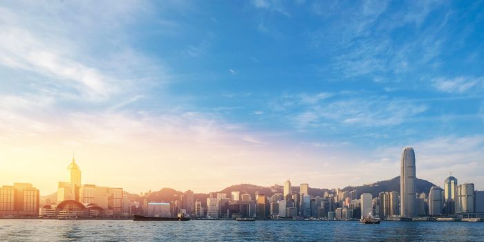 Hong Kong's Victoria Harbour in sunrise with text welcome to Hong Kong City