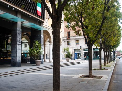 Cremona, Lombardy, Italy - May  5 6 7  2020 - man or woman walking or biking in deserted downtown  during covid outbreak lockdown phase 2