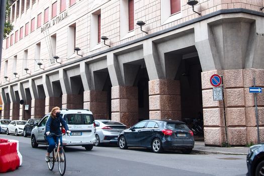 Cremona, Lombardy, Italy - May  5 6 7  2020 - man or woman walking or biking in deserted downtown  during covid outbreak lockdown phase 2