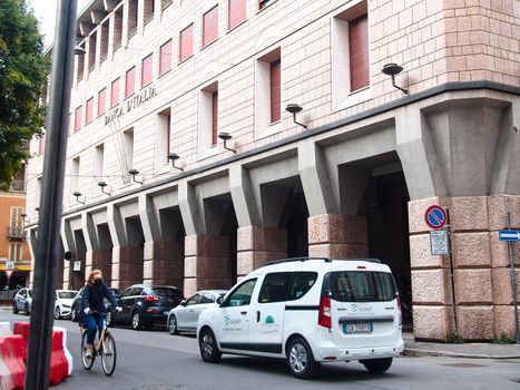 Cremona, Lombardy, Italy - May  5 6 7  2020 - man or woman walking or biking in deserted downtown  during covid outbreak lockdown phase 2