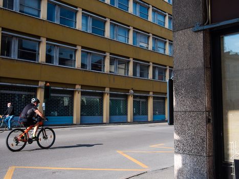 Cremona, Lombardy, Italy - May  5 6 7  2020 - man or woman walking or biking in deserted downtown  during covid outbreak lockdown phase 2