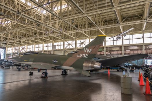 Oahu, Hawaii, USA. - January 10, 2020: Pearl Harbor Aviation Museum. Fighter jet VM 0-81 232 in hangar. Beige roof. Natural light through windows.