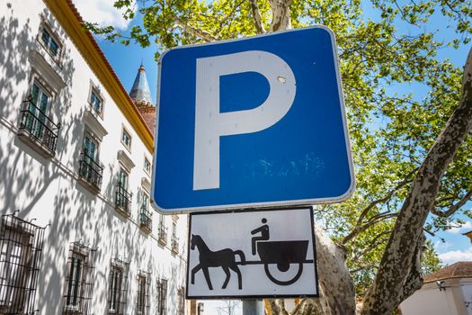 blue road sign indicating parking for a hitch horses in Evora, Portugal