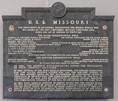 Oahu, Hawaii, USA. - January 10, 2020: Pearl Harbor. Japanese surrender memorial plate on USS Missouri is dark gray with white letters.