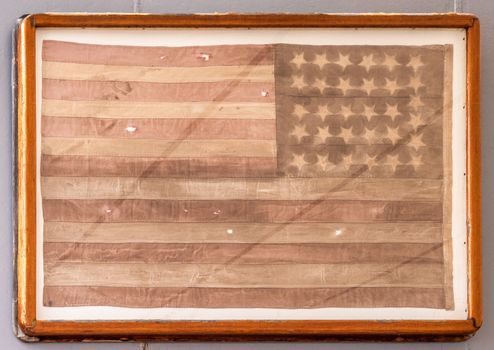 Oahu, Hawaii, USA. - January 10, 2020: Pearl Harbor. Original USA flag used during Japanese surrender ceremony on USS Missouri, framed behind glass.