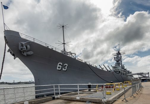 Oahu, Hawaii, USA. - January 10, 2020: Pearl Harbor. Bow of USS Missouri as seen from quay under cloudscape.