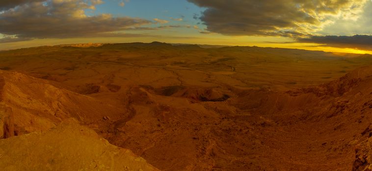 Panoramic sunset view of Makhtesh (crater) Ramon, in the Negev Desert, Southern Israel. It is a geological landform of a large erosion cirque