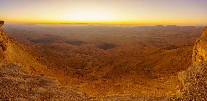 Panoramic sunrise view of Makhtesh (crater) Ramon, in the Negev Desert, Southern Israel. It is a geological landform of a large erosion cirque