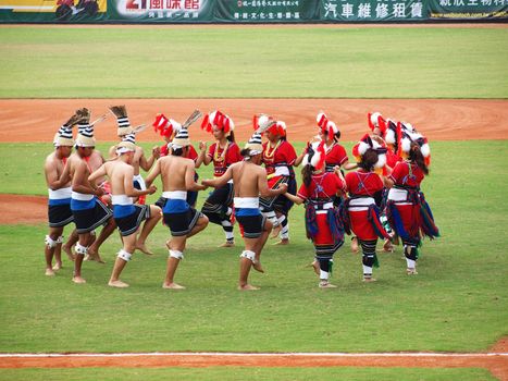 PINGTUNG, TAIWAN, APRIL 8: Aboriginal dancers perform before a Pro Baseball League game between the President Lions and the Lamigo Monkeys. The Lions won 2:0 on April 8, 2012 in Pingtung.
