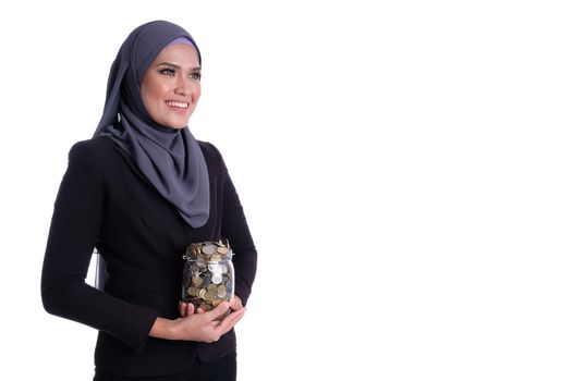 Pretty Muslim business woman hold coins in jar glass. Finance, investment, saving and insurance conceptual
