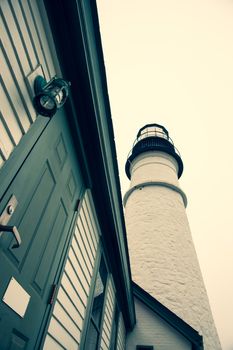 Portland Head Lighthouse towering skyward crossed processed image in Maine New England USA.