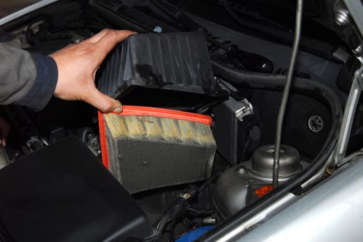 servicer is holding an old air filter