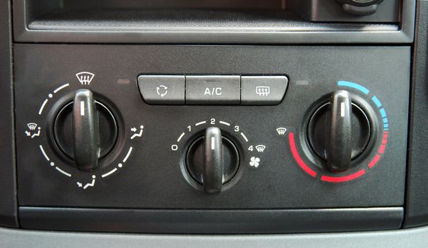 manual switches the air conditioning on the dashboard of the car