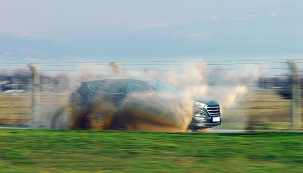 suv drives through flooded road