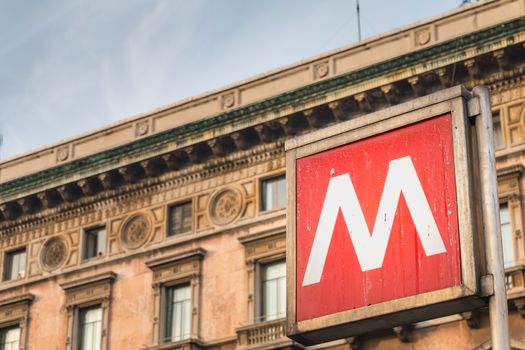 Milan, Italy - November 2, 2017: sign indicating the entrance to a metro station in the city center on a fall day