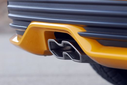 Close up of tailpipe on yellow sports car