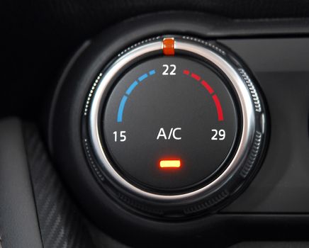 manual switches the air conditioning on the dashboard of the car