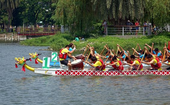 KAOHSIUNG, TAIWAN -- JUNE 1, 2014: Two unidentified teams take part in the 2014 Dragon Boat Event on the Lotus Lake.