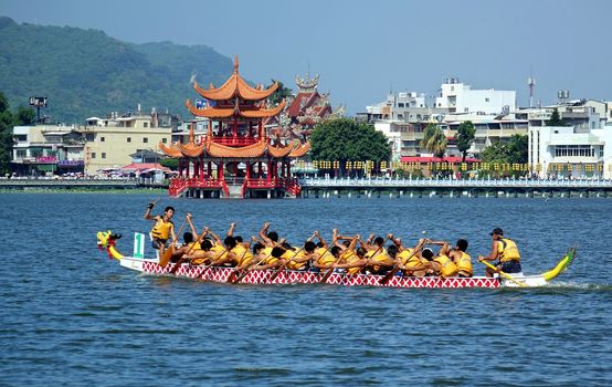 KAOHSIUNG, TAIWAN -- JUNE 1, 2014: An unidentified team takes part in the 2014 Dragon Boat Event on the Lotus Lake.