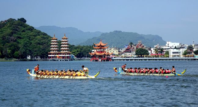 KAOHSIUNG, TAIWAN -- JUNE 1, 2014: Two unidentified teams take part in the 2014 Dragon Boat Event on the Lotus Lake.
