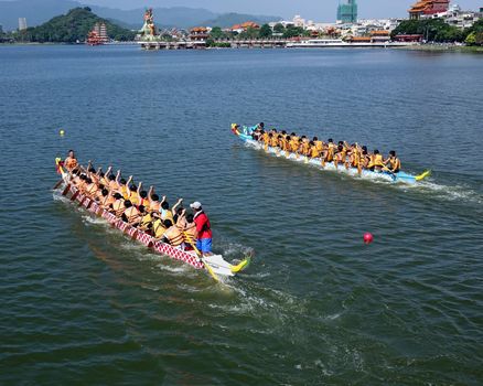 KAOHSIUNG, TAIWAN -- JUNE 1, 2014: Two unidentified teams take part in the 2014 Dragon Boat Event on the Lotus Lake.
