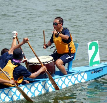 KAOHSIUNG, TAIWAN -- JUNE 1, 2014: An unidentified team takes part in the 2014 Dragon Boat Event on the Lotus Lake.