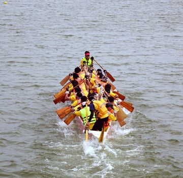 KAOHSIUNG, TAIWAN - MAY 25, 2014: An unidentified team competes in the 2014 Dragon Boat Races on the Lotus Lake.