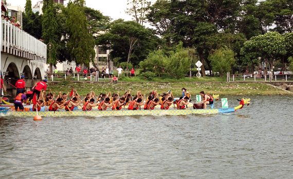KAOHSIUNG, TAIWAN - MAY 25, 2014: Two unidentified teams compete in the 2014 Dragon Boat Races on the Lotus Lake.