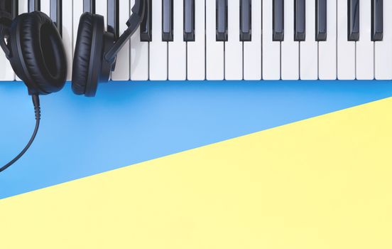 Music keyboard instrument with headphone on blue yellow copy space for Music concept