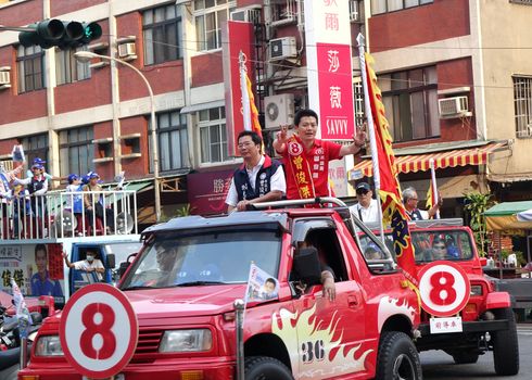 KAOHSIUNG, TAIWAN -- NOVEMBER 27, 2014: City council candidate Zeng Jun Jie parades through the streets in the run up to the local elections.
