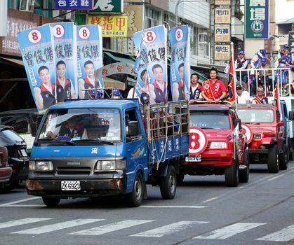 KAOHSIUNG, TAIWAN -- NOVEMBER 27, 2014: City council candidate Zeng Jun Jie parades through the streets in the run up to the local elections.