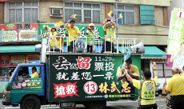 KAOHSIUNG, TAIWAN -- NOVEMBER 28, 2014: Supporters of city council candidate  Lin Low Chung parade through the streets in the run up to the local elections.