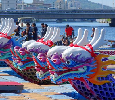 KAOHSIUNG, TAIWAN -- JUNE 14, 2015: Boats with the traditional dragon head sculpture design are prepared for the yearly Dragon Boat Races on the Love River.
