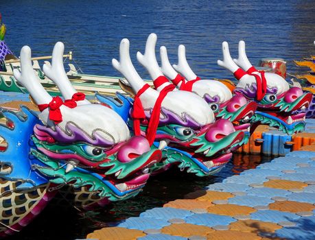 KAOHSIUNG, TAIWAN -- JUNE 14, 2015: Boats with the traditional dragon head sculpture design are prepared for the yearly Dragon Boat Races on the Love River.