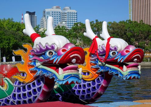 KAOHSIUNG, TAIWAN -- JUNE 14, 2015: Boats with the traditional dragon head sculpture design are prepared for the yearly Dragon Boat Races on the Love River.