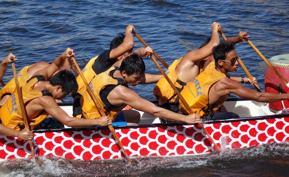 KAOHSIUNG, TAIWAN -- JUNE 14, 2015: An unidentified team of rowers trains for the upcoming Dragon Boat Races on the Love River.