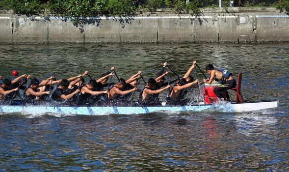 KAOHSIUNG, TAIWAN -- JUNE 14, 2015: An unidentified team of rowers trains for the upcoming Dragon Boat Races on the Love River.