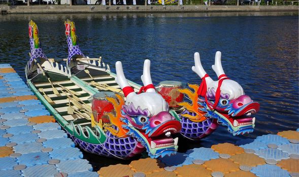 KAOHSIUNG, TAIWAN -- JUNE 14, 2015: Boats with the traditional dragon head sculpture design are prepared for the yearly Dragon Boat Races on the Love River.