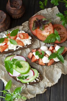 Italian bruschetta with tomatoes, parmesan, cucumber, basil, mozarella, garlic and olive oil. Mix bruschetta flat lay