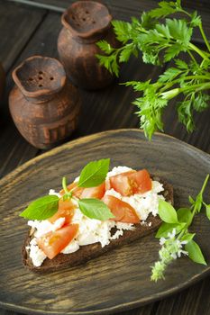 Bruschetta with ricotta cheese, fresh basil and tomato. Vertical image