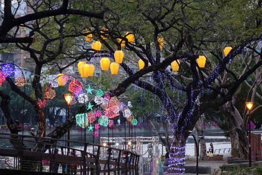 KAOHSIUNG, TAIWAN -- MARCH 6, 2015: Colorful lanterns to celebrate the Chinese year of the goat decorate the trees along the banks of the Love River during the traditional Lantern Festival.