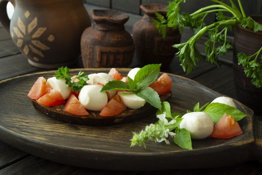 Bruschetta with tomatoes, mozzarella and basil. Traditional italian appetizer or snack