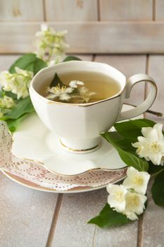 Jasmine herbal tea on a shabby wooden table, vertical image