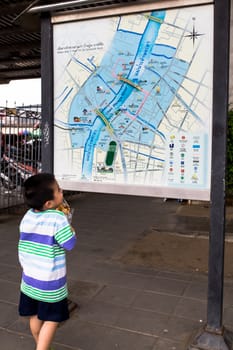 Bangkok, Thailand, August 15 2018. This boy is looking at a map in Bangkok.