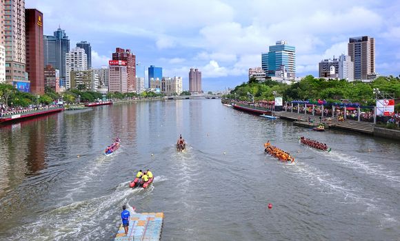 KAOHSIUNG, TAIWAN -- JUNE 9, 2016: Four unidentified teams compete in boat races on the Love River during Dragon Boat Festival.