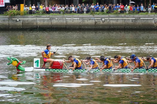 KAOHSIUNG, TAIWAN -- JUNE 9, 2016: A team of international students competes in a boat race on the Love River during Dragon Boat Festival.