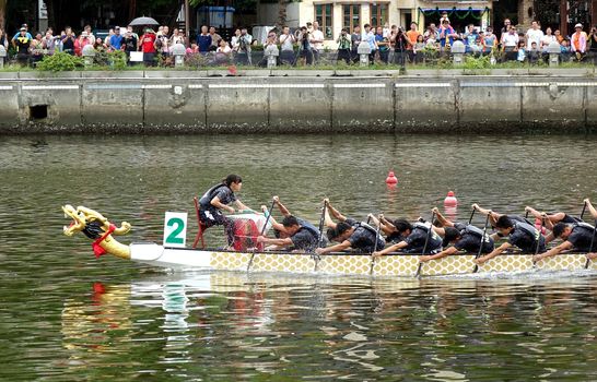 KAOHSIUNG, TAIWAN -- JUNE 9, 2016: The Taiwan navy team competes in a boat race on the Love River during Dragon Boat Festival.