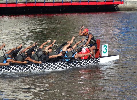 KAOHSIUNG, TAIWAN -- MAY 27, 2016: An unidentified team trains on the Love River in preparation for the upcoming Dragon Boat Festival.